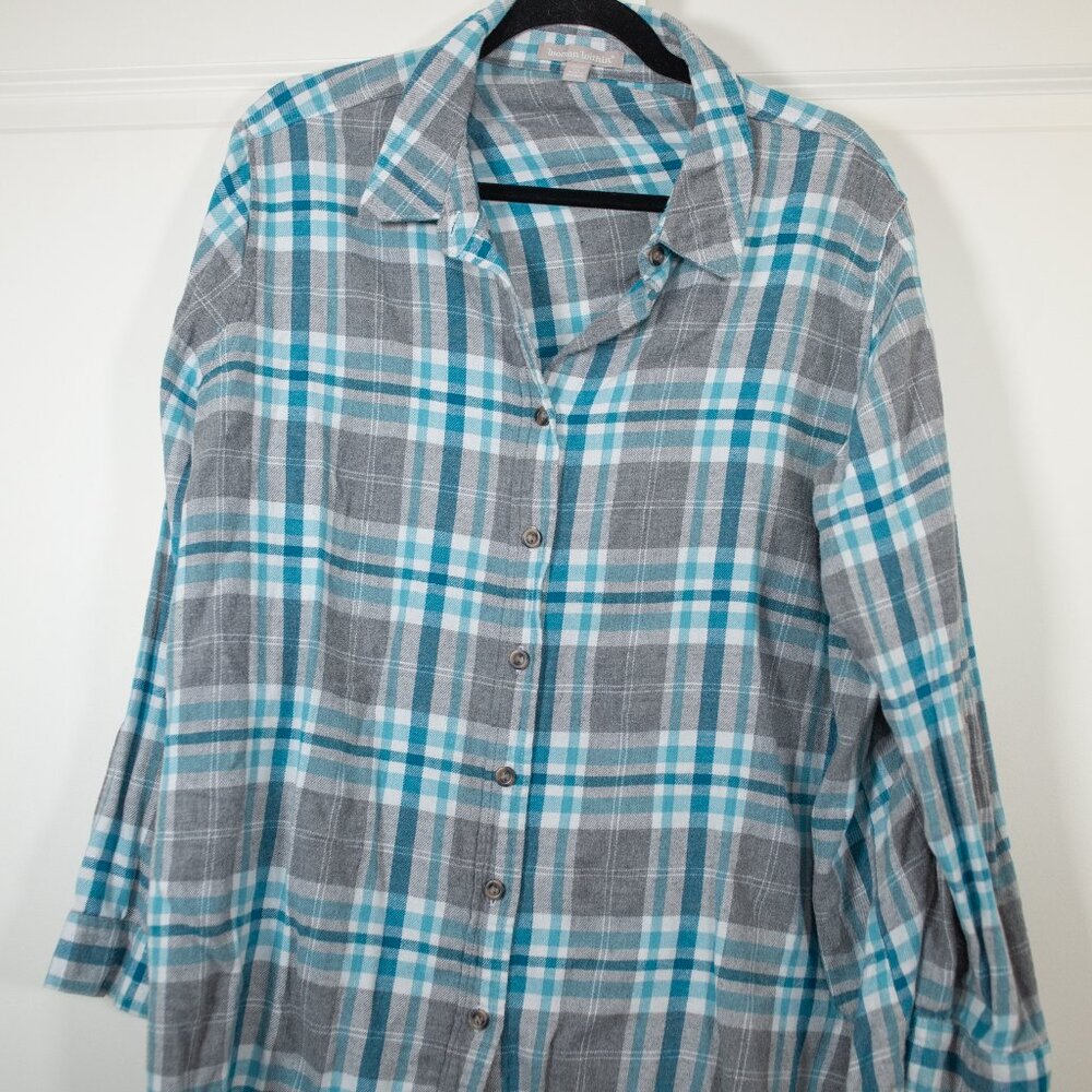 Woman within blue and gray plaid flannel shirt